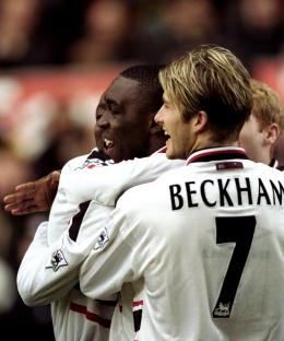 David Beckham and Andy Cole of Manchester United celebrating a goal.