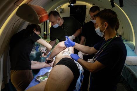 Medical personnel attending to a patient in a confined space.