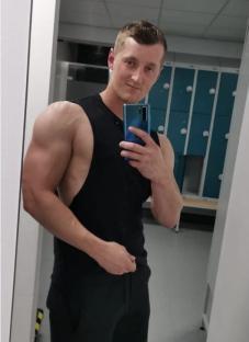 Man taking a selfie in a locker room.