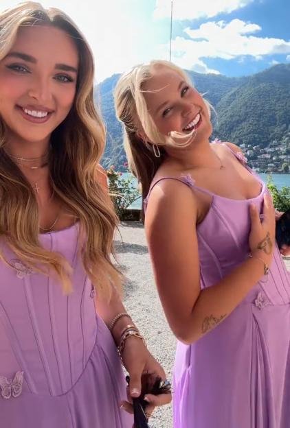 JoJo Siwa in a purple dress next to a woman with long blonde hair, both smiling.