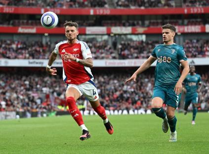 Ben White of Arsenal and Milos Kerkez of Bournemouth during a soccer match.