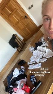 A photo of a table with many socks, a soda can, and a remote; text overlay reads