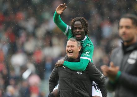 Darko Gyabi of Plymouth Argyle celebrates with coach Kevin Nancekevell.