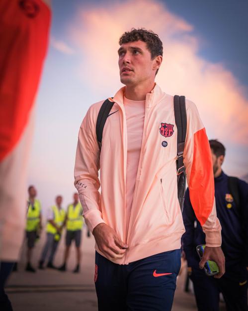 Andreas Christensen in a peach and orange FC Barcelona jacket.