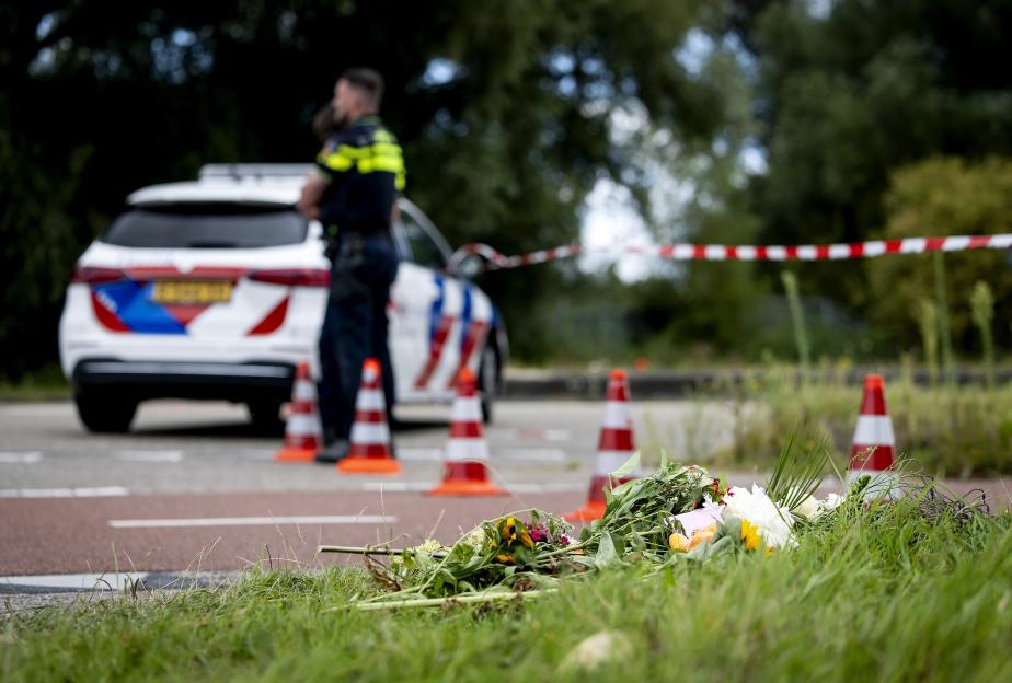 Flowers left at a roadside crime scene.