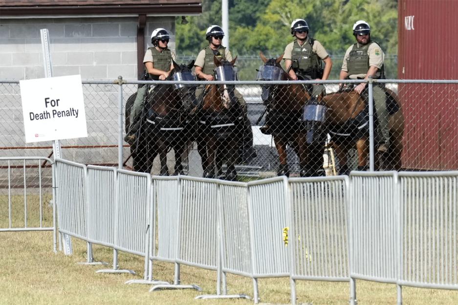 Mounted guards watch a death penalty demonstration area.