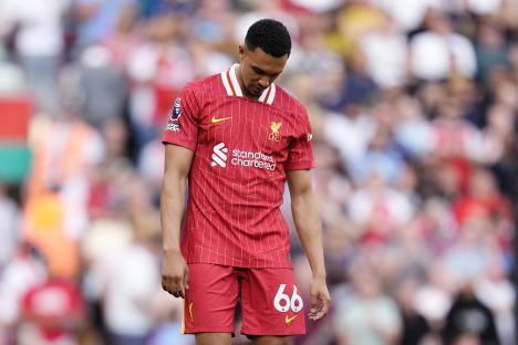 Trent Alexander-Arnold looking dejected during a soccer match.