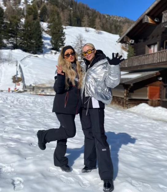 Leigh and her bride posing in snow after receiving a bad edit.