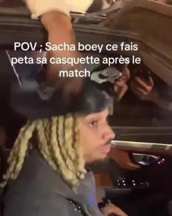 Man with blonde dreadlocks in a car after a match.