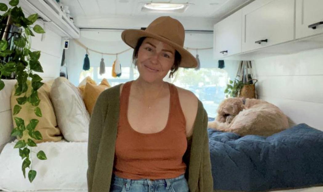 Woman in a van with her dog.