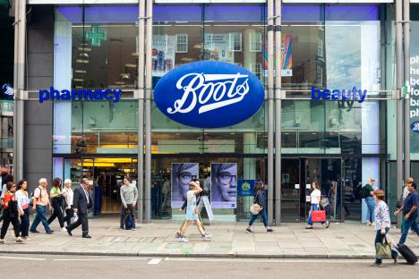 People walking past a Boots pharmacy in London.