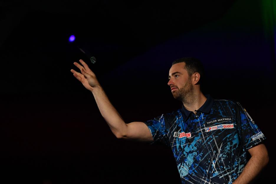 Luke Humphries throws a dart in a showcase match in Geneva, Switzerland.