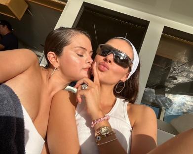 Selena Gomez and Nicola Peltz embracing on a boat.