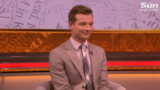Man in suit on television show.