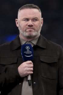 Wayne Rooney holding a UEFA Champions League Amazon Prime microphone.