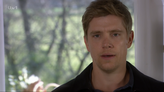 Screenshot of a man speaking.