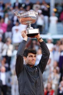 Carlos Alcaraz of Spain holding up the winner's trophy.