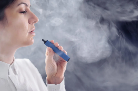 Woman vaping an e-cigarette.