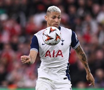 Richarlison of Tottenham Hotspur controlling the ball during a soccer match.