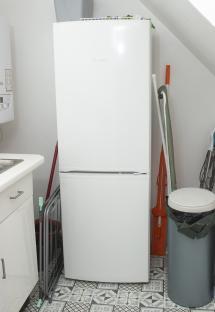 White Bosch refrigerator in a kitchen corner.
