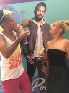 Two people with drinks posing with a Craig David cutout at Ibiza Rocks Hotel.