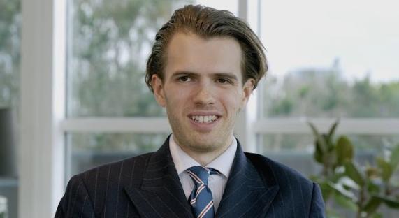 Portrait of a smiling man in a suit.