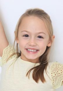 Headshot of Amelie Bea Smith, the fourth voice of Peppa Pig.