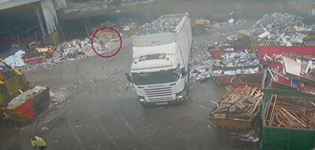 Aerial view of a garbage truck in a junkyard.