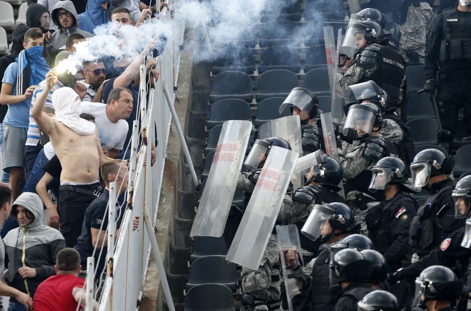 Riot police clashing with soccer fans.