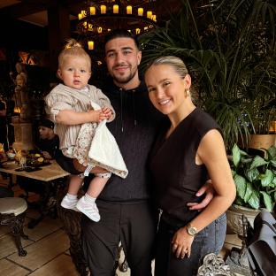 Molly Mae Hague, Tommy Fury, and their baby daughter in a restaurant.