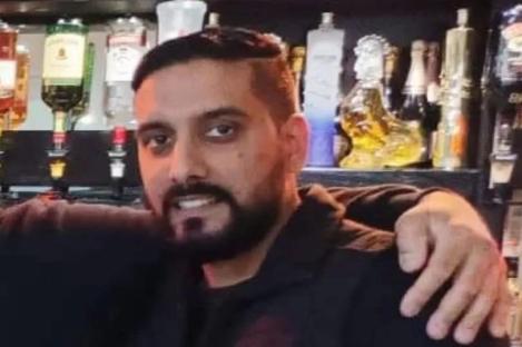 Restaurant owner in his 30s stabbed to death inside Lloyds bank is pictured – as two men arrested