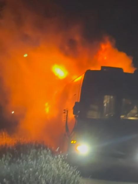 Tour bus engulfed in flames.
