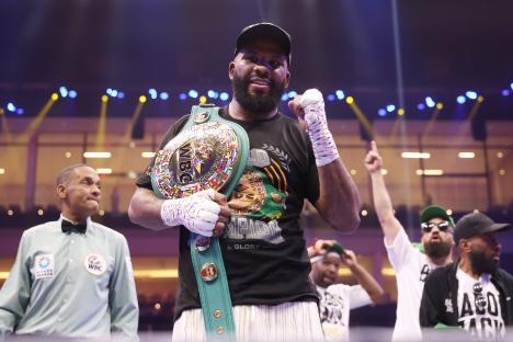 Badou Jack holding the WBC World Cruiserweight title belt after a boxing match.