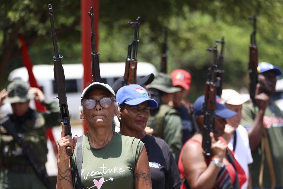 People hold rifles during military training.
