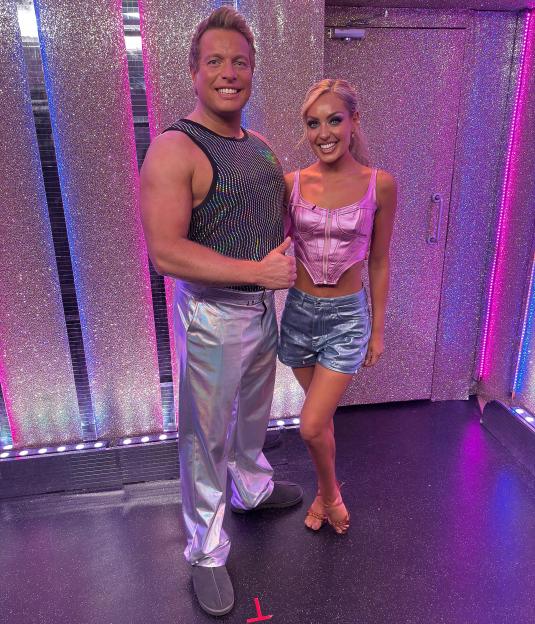 Thomas Skinner and Amy Dowden in a sparkling room.