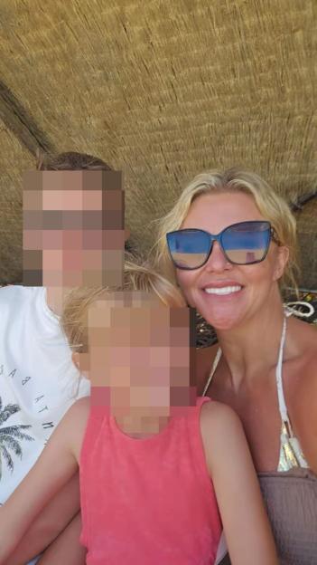 Woman with two children, faces blurred for privacy.