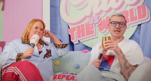 Two people sitting on a couch during an interview.