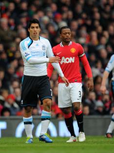 Patrice Evra and Luis Suarez on a soccer field.