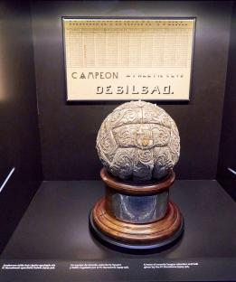 Ornate silver soccer ball on wooden base, displayed with a historical league record chart; FC Athletic Bilbao.