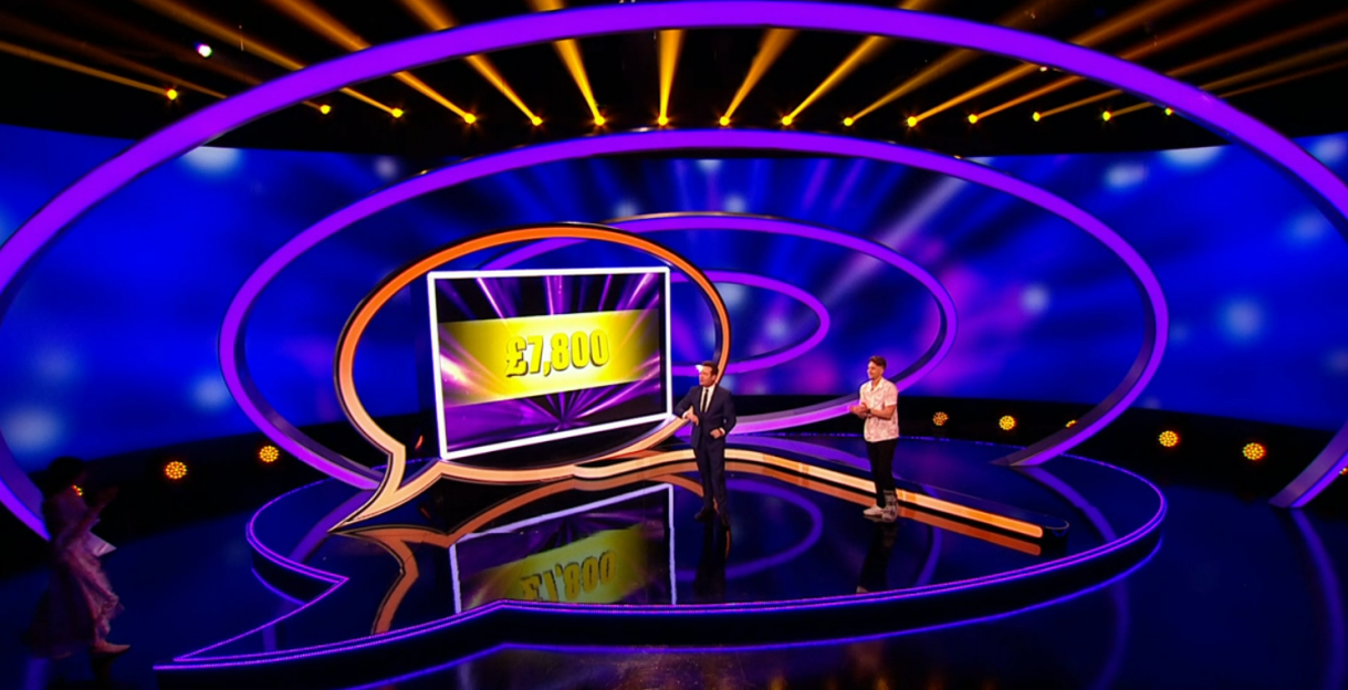 Two men on a game show set, £7,800 displayed on a screen.