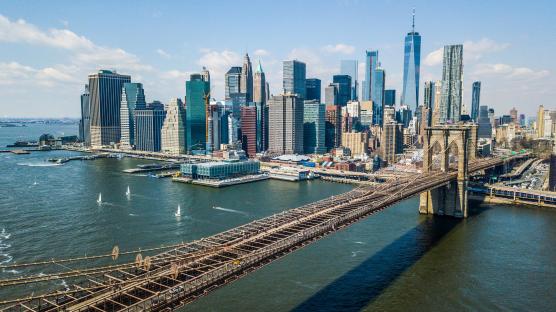 Aerial view of the Brooklyn Bridge and the downtown Manhattan skyline.