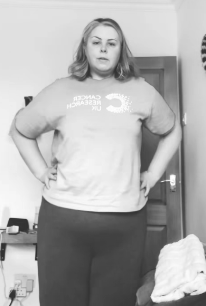 Black and white photo of a woman wearing a Cancer Research UK t-shirt.