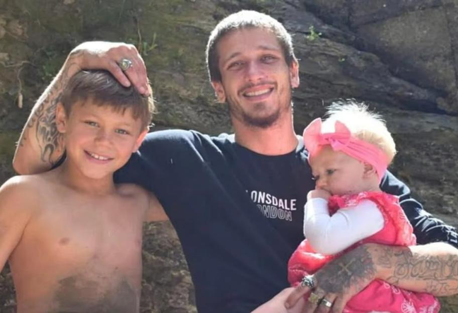 Photo of a father with his two young children.