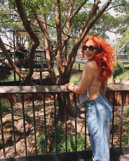 Woman with red hair at a zoo.