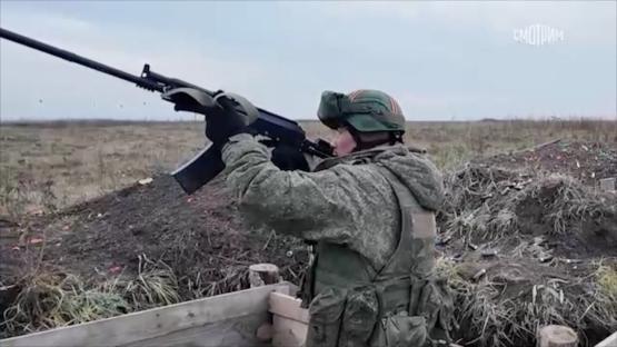 A soldier firing a rifle.