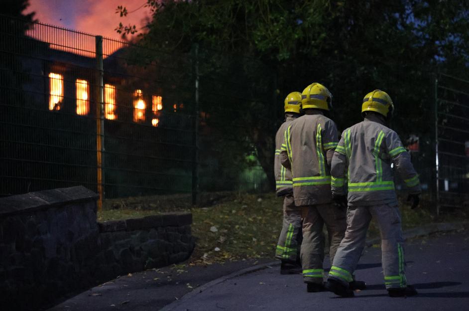 Firefighters at the scene of a burning building.