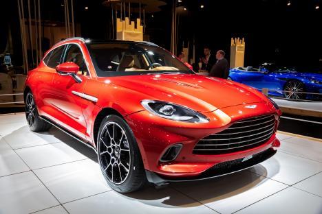 Red Aston Martin DBX SUV at a car show.