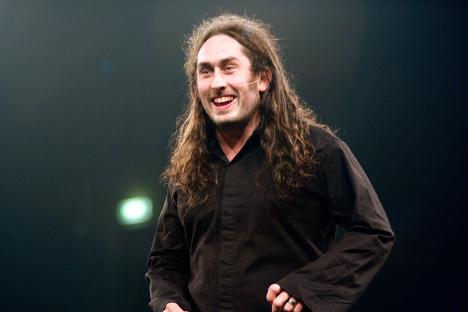 Ross Noble performing on stage.