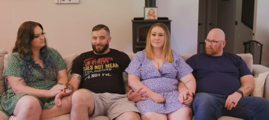 A polyamorous family with four adults sitting on a couch.
