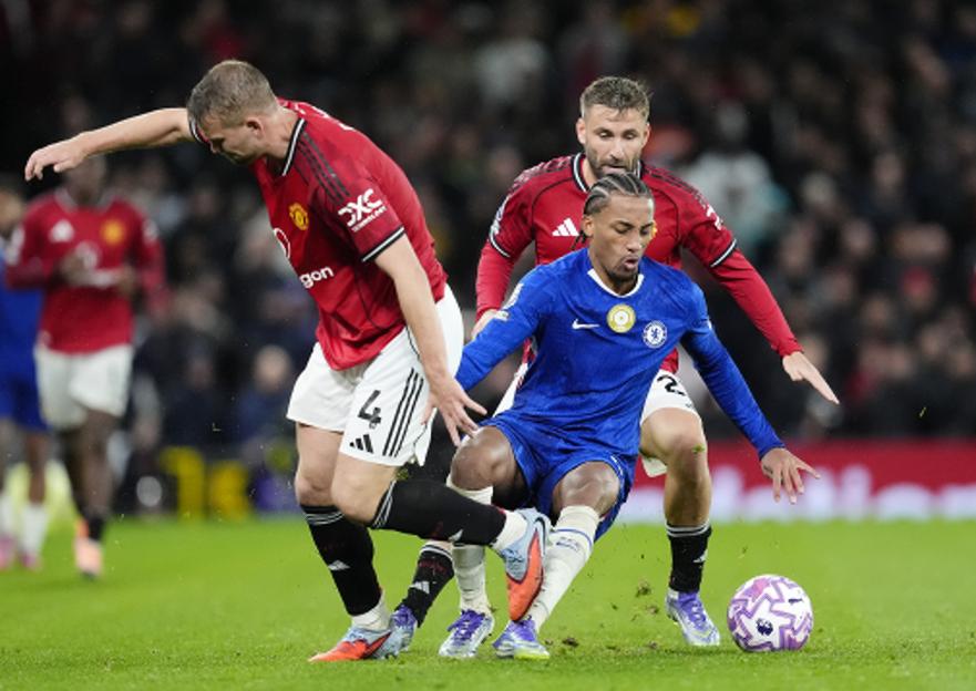 Chelsea's Joao Pedro being fouled by Manchester United's Matthijs de Ligt during a Premier League match.